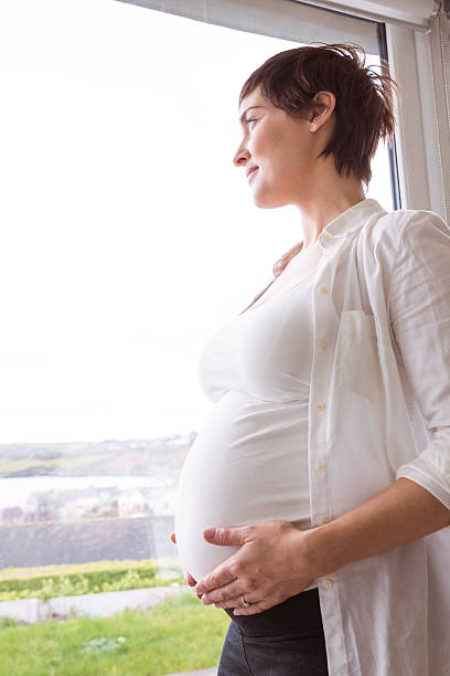 istock Pregnant woman holding her bump 485112714