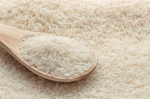 istock Close up jasmine rice with wooden spoon on rice background. 485113878