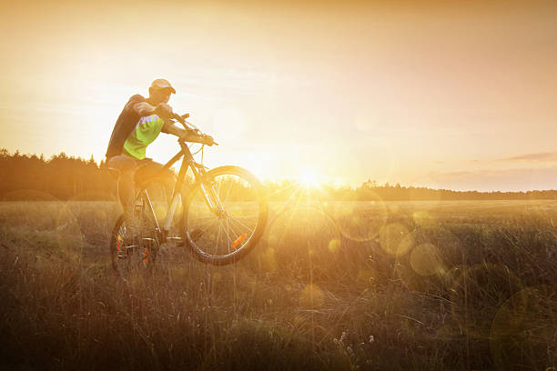 istock Young man riding a bike at sunset 485115325