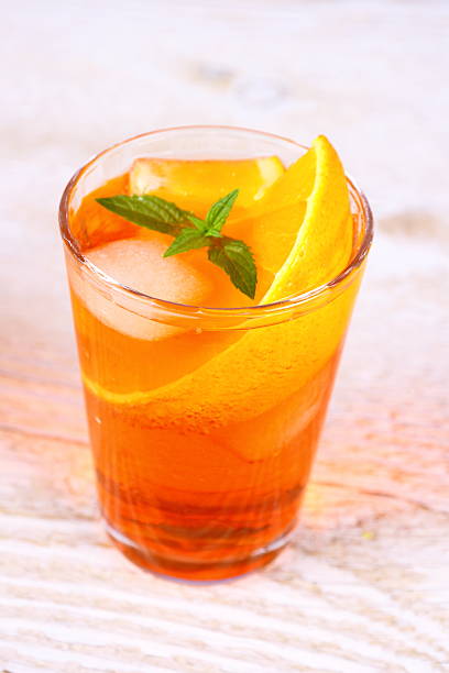 istock Orange cocktail on white wooden background 485115739