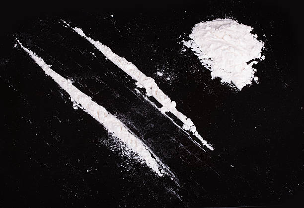 cocaine powder in lines cocaine powder in lines on a black background cocaine stock pictures, royalty-free photos & images