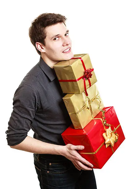 Photo of Holiday. Young man giving presents gifts boxes