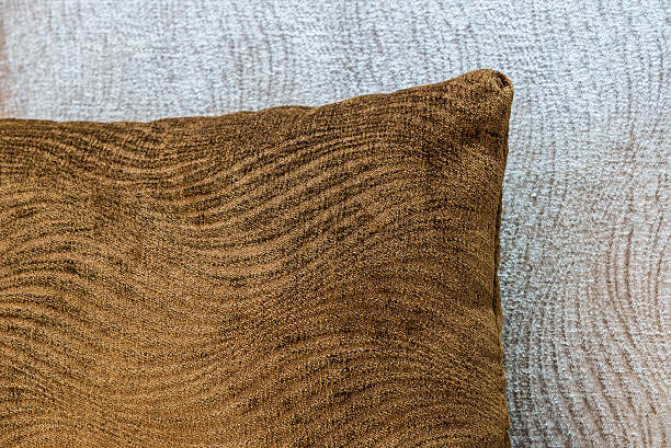 istock Close up soft brown pillow on a light beige sofa 485118154