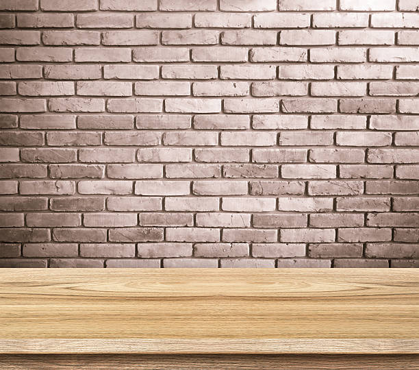 istock Empty wood table and red brick wall in background 485118712