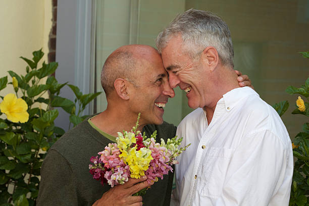 Senior Gay Male Couple with Bouquet of Flowers stock photo