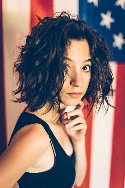 istock Girl posing in front of USA flag 485124416