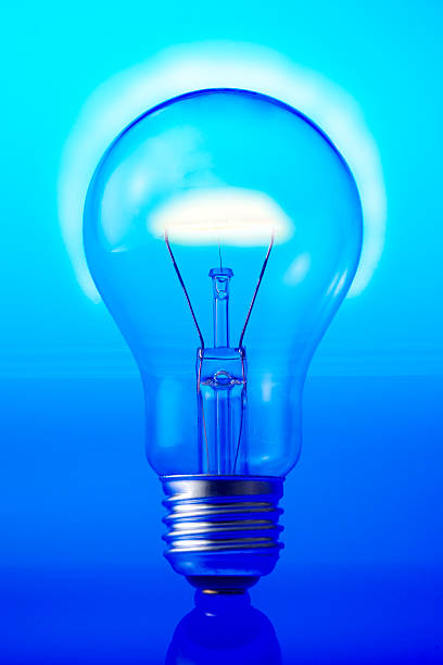 istock Close-up of illuminated light bulb on blue background 485124784