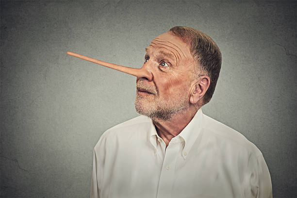 Man with long nose looking up. Liar concept Man with long nose looking up avoiding eye contact isolated on grey wall background. Liar concept. Human face expressions, emotions, feelings. falsehood stock pictures, royalty-free photos & images