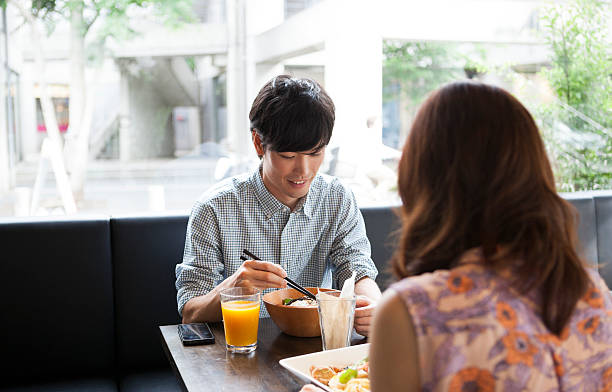 istock Charming asian guy eating out with a girl 485124984