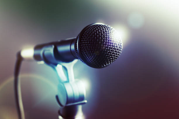 istock Close-up of vocal microphone with stage lighting 485125050