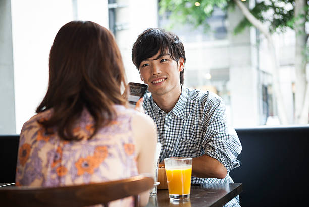 istock Handsome asian man with girlfriend in cafe 485125060