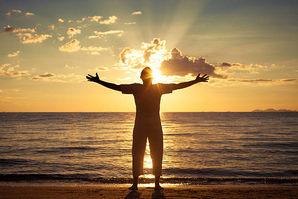 istock Man with his hands up at the sunset time 485129078