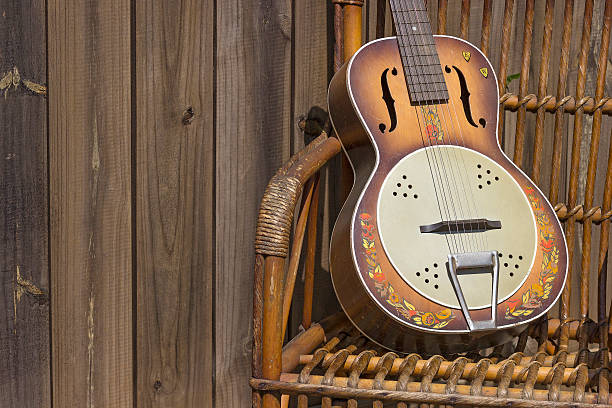 istock old guitar on a wooden chair 485129498