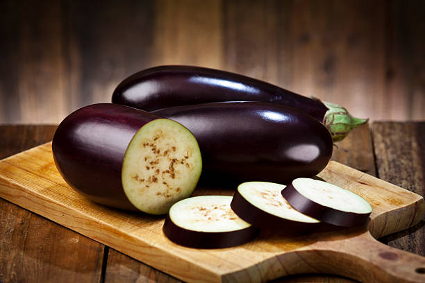 istock Eggplant on wooden cutting board 485129508