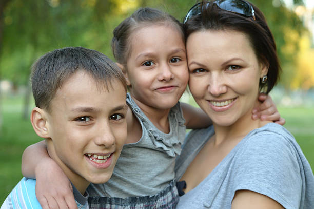 istock Mother with her children in summer park 485131420