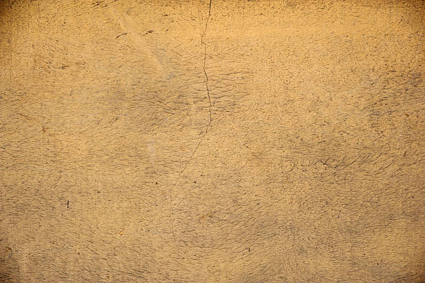 istock Texture of old wall covered with yellow stucco 485133896
