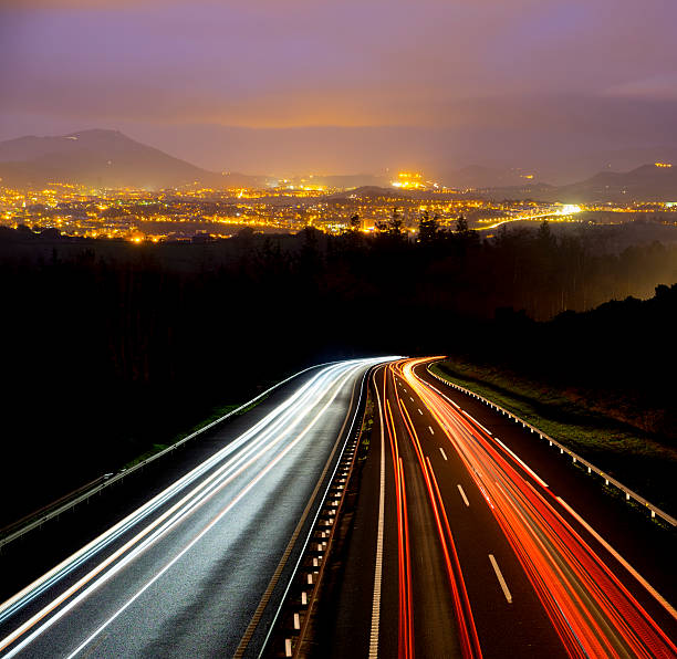 car lights at night on the road going to the city
