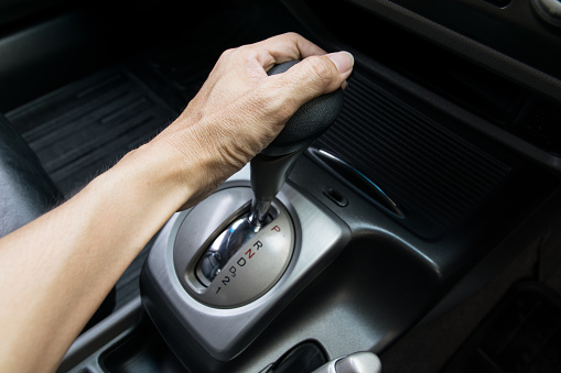 hand on automatic gear shift, Man hand shifting an automatic car