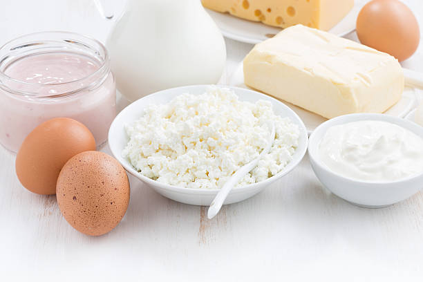 istock fresh dairy products on white wooden background, horizontal 485135462