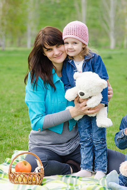 istock Mother hugs daughter at a picnic 485143452