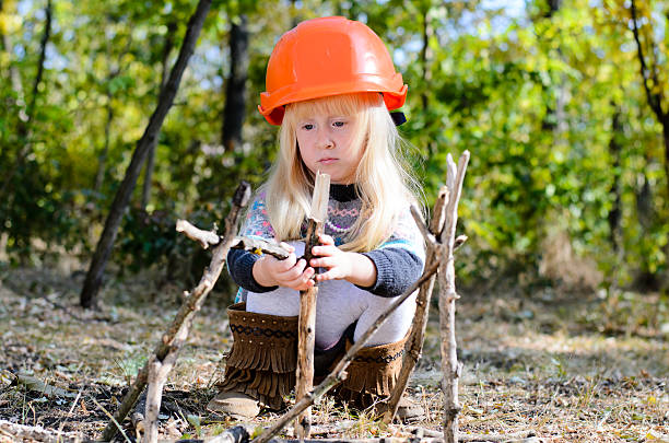 istock Little Girl with Helmet Playing with Sticks 485145626