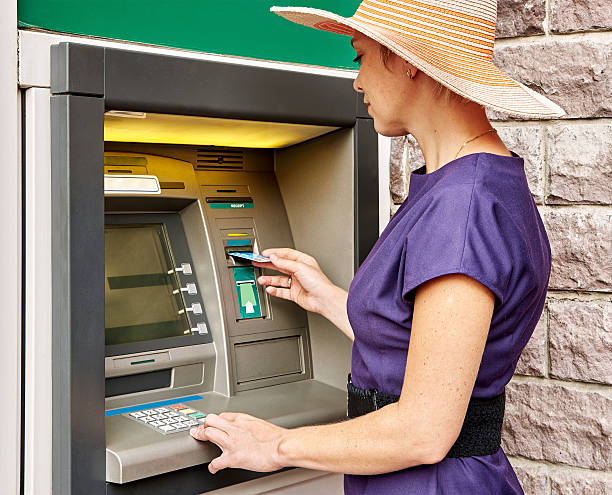 istock Pretty woman operates ATM 485146746