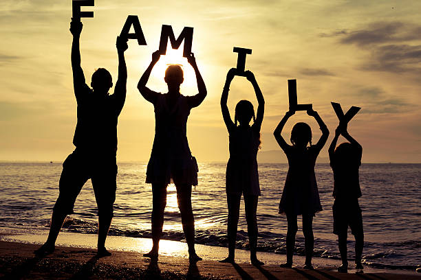 istock Happy family standing on the beach 485150096