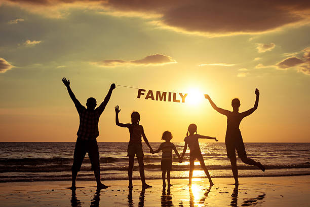 istock Happy family standing on the beach 485150098