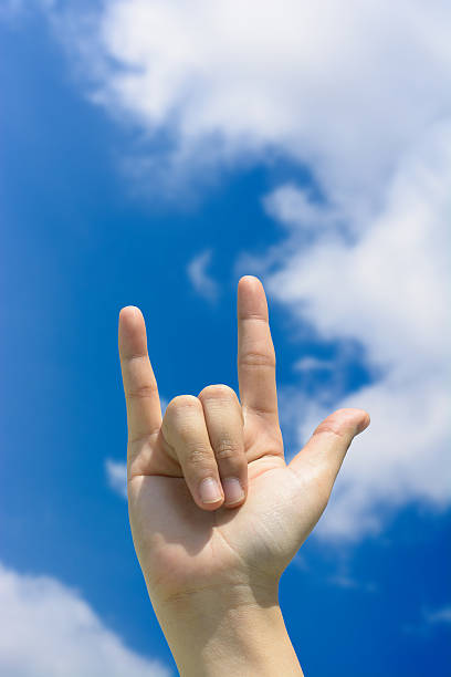 istock Love hand sign on blue sky 485150702