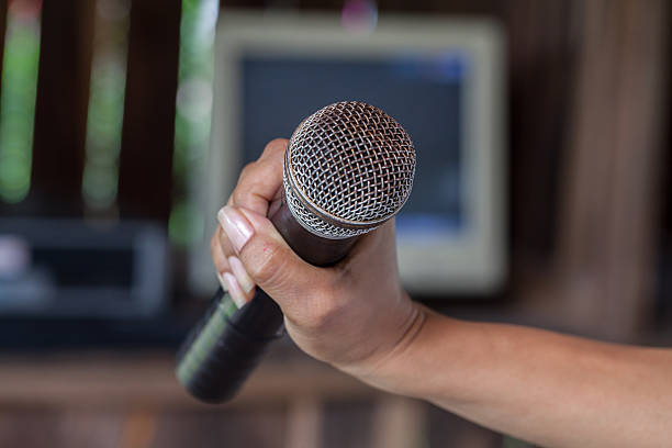 istock Old black microphone in hand, depth of field 485151168