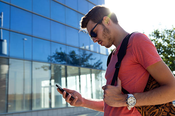 istock Handsome young man using his mobile phone in the street. 485151394
