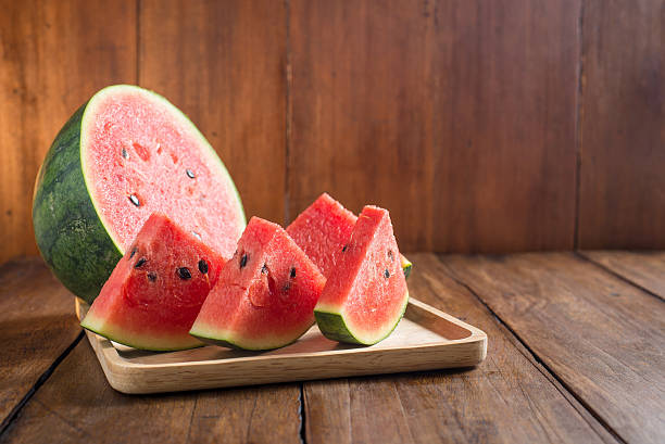 istock slices watermelon on wooden background 485151808