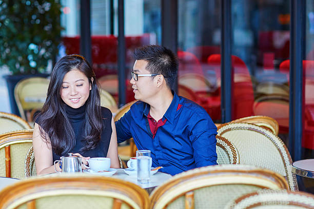 istock Young romantic Asian couple in Parisian cafe 485152266