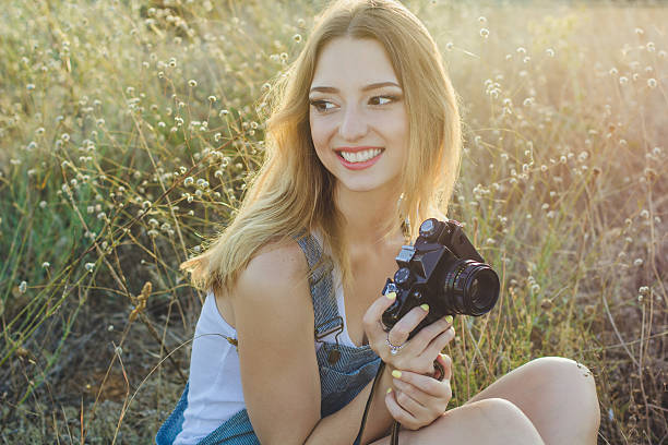 istock Happy smiling girl making pictures by old camera 485154840