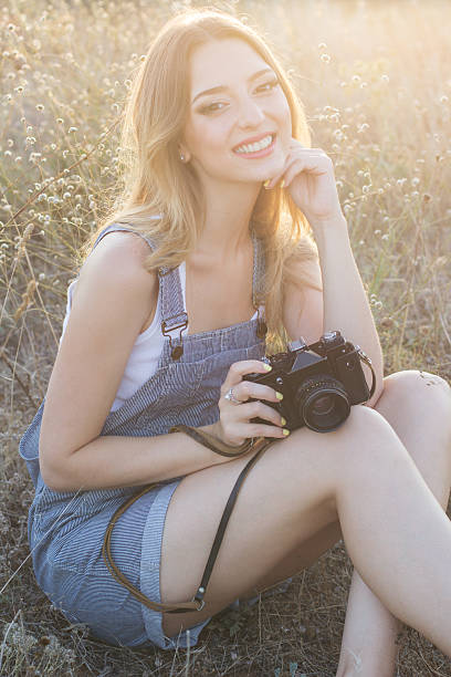 istock Happy smiling girl making pictures by digital camera 485154844
