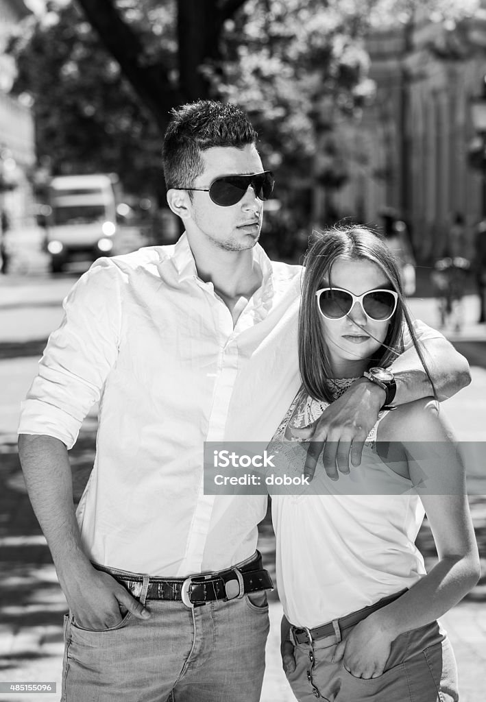 young couple in sunglasses young couple in sunglasses in summer, city outdoor, black and white photography 2015 Stock Photo