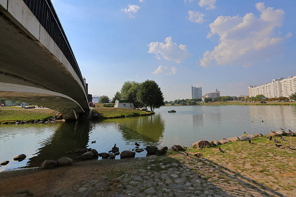 istock Small pedestrian concrete bridge over a narrow city river 485155390