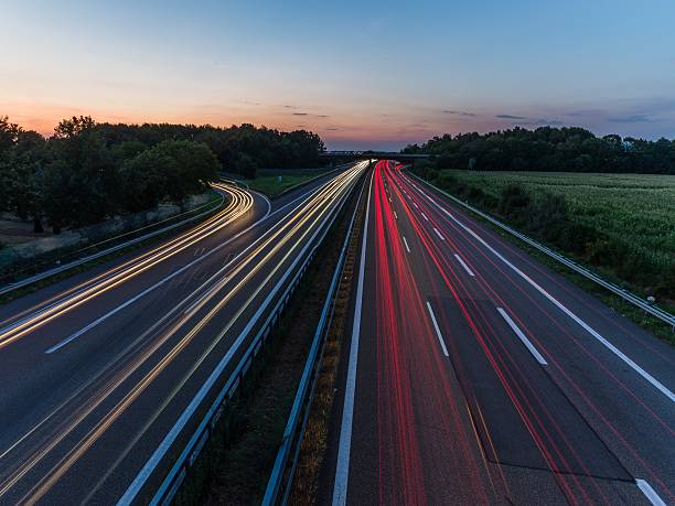 istock german highway at sunset with light trails from passing cars 485157984