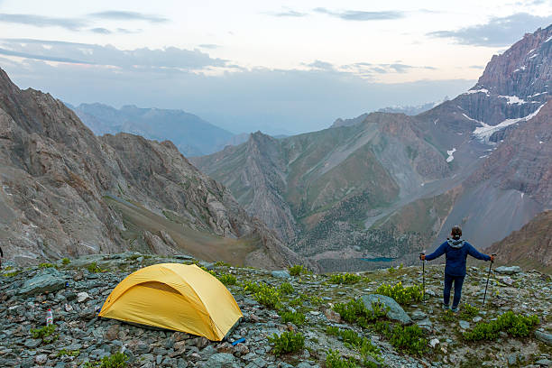 istock Hiker with walking poles and climbing tent 485158880