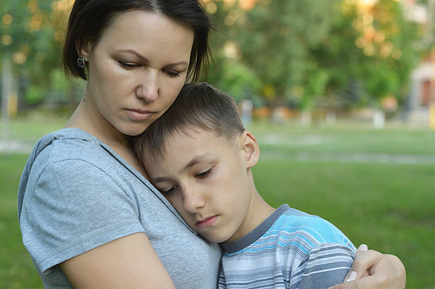 istock Sad mother with son  in  park 485158940