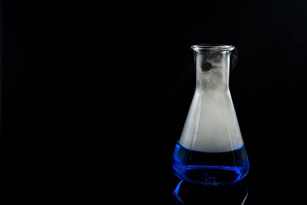 istock glas with a blue liquid used for chemical analysis 485158968