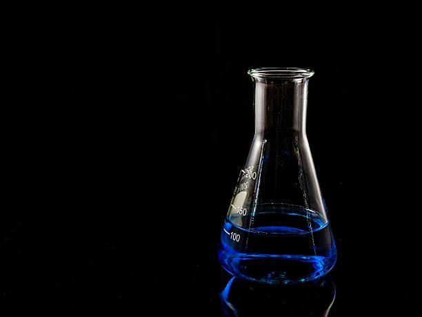 istock glas with a blue liquid used for chemical analysis 485159026
