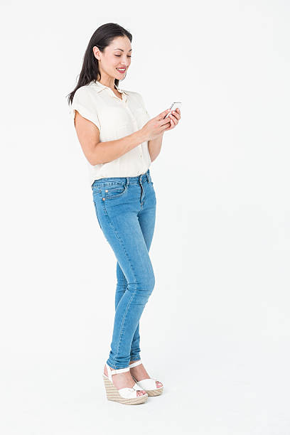 istock Smiling brunette texting with her mobile phone 485160166