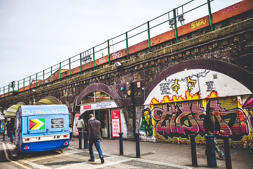 Lodz, Poland - May 21, 2023: Traugutta street panorama with Miastoprojekt and Textilimpex office towers and famous Arthur Rubinstein mural in historic city center of Lodz old town