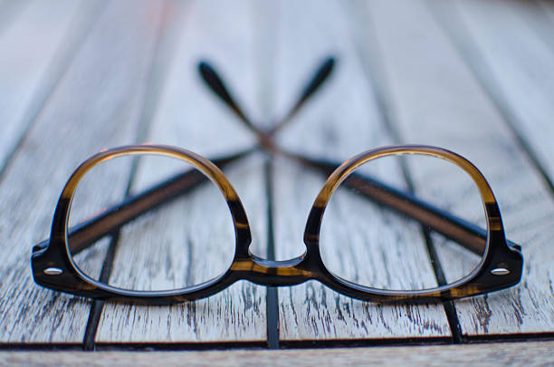 istock Pair of glasses on a wooden table 485161246