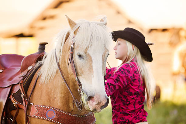 istock Cowgirl preparing her horse 485163117