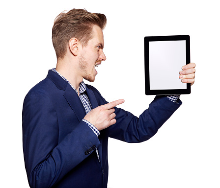 Studio shot of an angry young man shows on a digital tablet.
