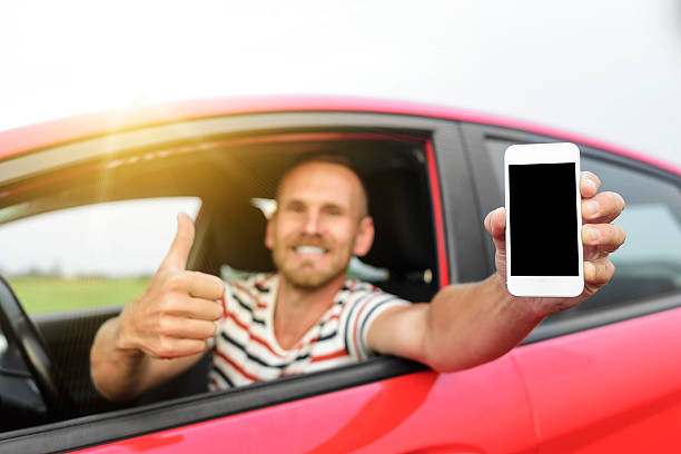 istock Man in car showing smart phone 485163606
