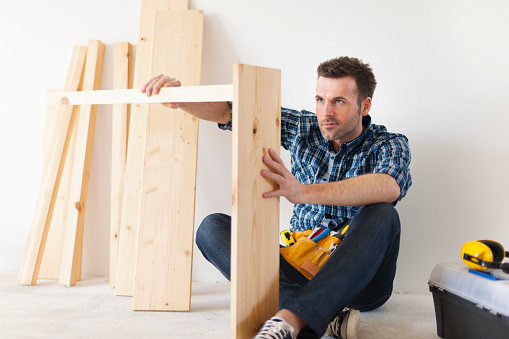 Handsome carpenter working on new furniture