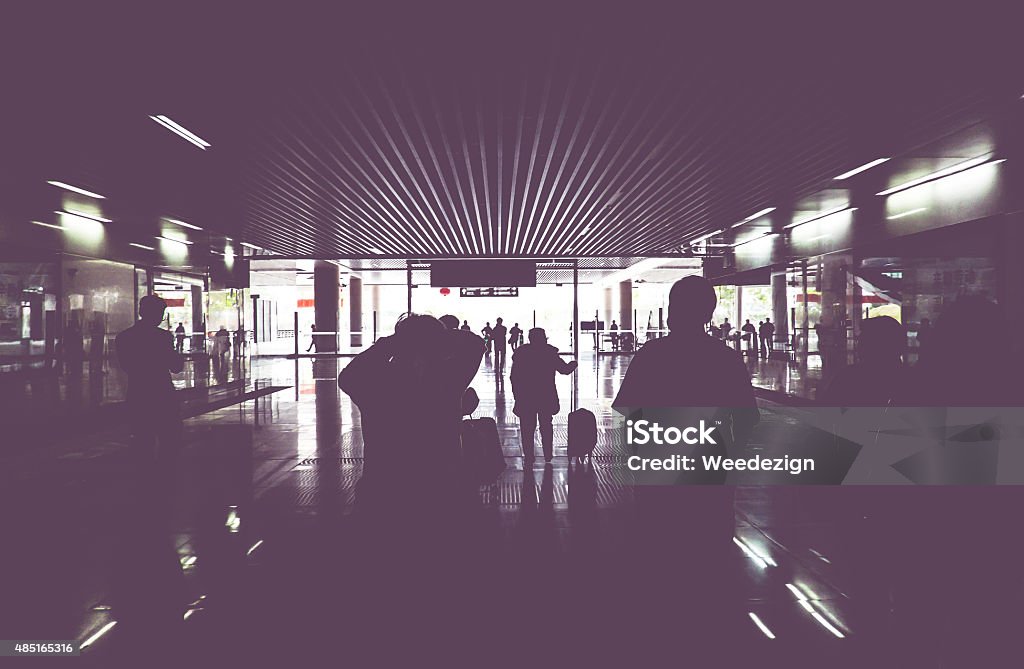 Vintage filter : silhouette of passenger walking through train g Vintage filter : silhouette of passenger walking through train gate with light at the end of gate. 2015 Stock Photo